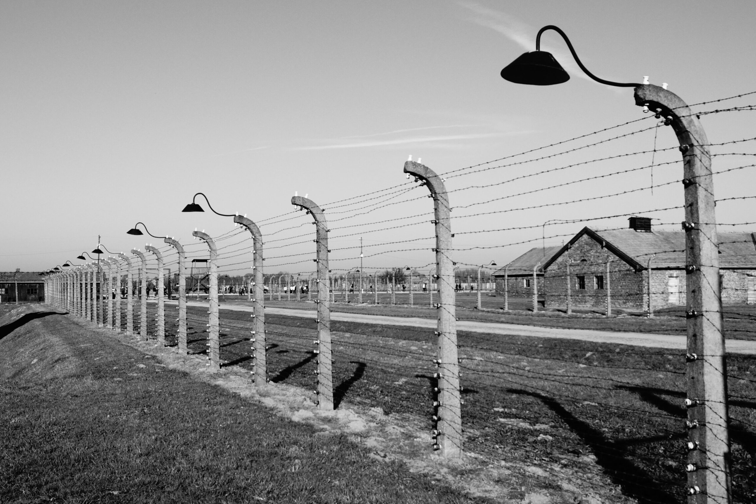 Barbed wire fence and barracks at the Auschwitz-Birkenau Memorial near Krakow